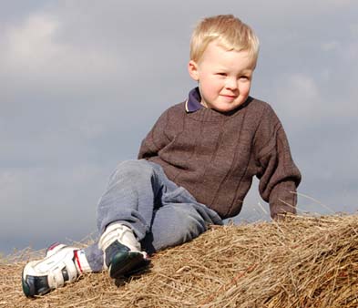 Boy on Bale of Hay