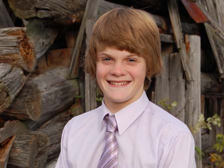 Boy at Log Building